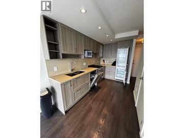 Vancouver apartment for rent - A kitchen with wooden floors and cabinets.