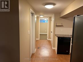Aurora (Aurora Heights) apartment for rent - A kitchen area with a refrigerator and a doorway leading to another room.