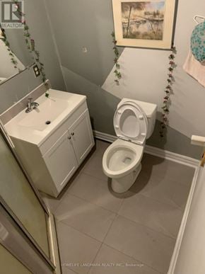 Hamilton (Ainslie Wood) apartment for rent - A white toilet in a bathroom with a white cabinet and a mirror.
