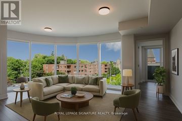 Toronto (Forest Hill North) condo for rent - A living room with a large couch and a view of the city.