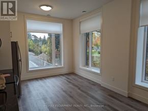 Waterloo condo for rent - A room with a large window and a sliding door.