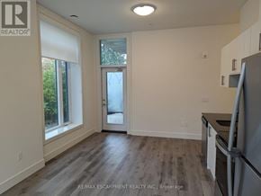 Waterloo condo for rent - A kitchen with a refrigerator, sink, and cabinets.