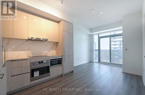 Vaughan (Vaughan Corporate Centre) condo for rent - A modern kitchen with wooden cabinets and stainless steel appliances.