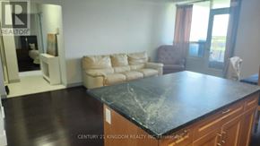 Toronto (Flemingdon Park) condo for rent - A living room with a black countertop and a brown armchair.