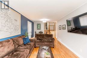 Barrie (Sunnidale) apartment for rent - A living room with a brown couch and a map on the wall.