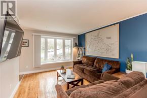 Barrie (Sunnidale) apartment for rent - A living room with a brown couch and a large window.