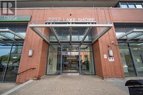 Toronto (Mimico) condo for rent - The front of a building with a glass entrance and a sign that reads "2212 Lake Shore".