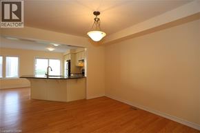Kitchener townhouse for rent - A well-lit kitchen with wooden floors and a large island.