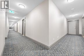 Toronto (Bayview Village) condo for rent - A long hallway with doors on both sides and a carpeted floor.
