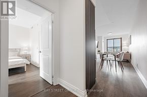 Toronto (Bayview Village) condo for rent - A bedroom with a bed, a chair, and a dining table is shown.