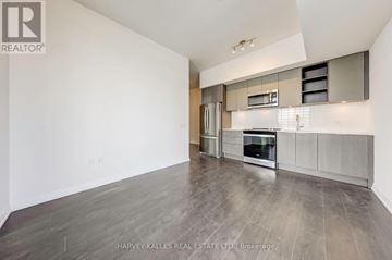 Toronto (Mount Pleasant West) condo for rent - A spacious kitchen with a refrigerator, oven, and microwave.