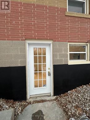 Toronto (Highland Creek) apartment for rent - A white door with a glass panel is set in a brick wall.