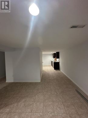 Toronto (Highland Creek) apartment for rent - A room with a light on the ceiling and a box on the floor.