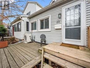 Toronto (Oakridge) apartment for rent - A house numbered 23 with a wooden deck in front.