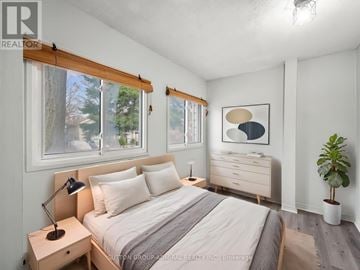 Toronto (Oakridge) apartment for rent - A white kitchen with a stove top oven and a refrigerator.