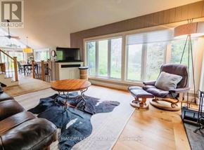 Georgian Bay (Baxter) apartment for rent - A living room with a brown leather couch and a wooden coffee table.