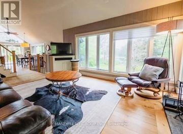 Georgian Bay (Baxter) apartment for rent - A living room with a brown leather couch and a wooden coffee table.