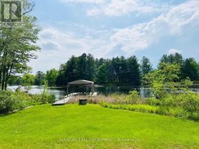 Georgian Bay (Baxter) apartment for rent - A gazebo sits on a grassy area by a lake.