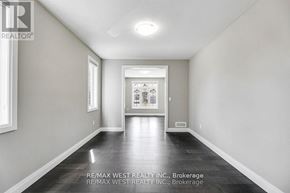 Thames Centre apartment for rent - A long hallway with a brokerage sign from RE/MAX West Realty Inc.