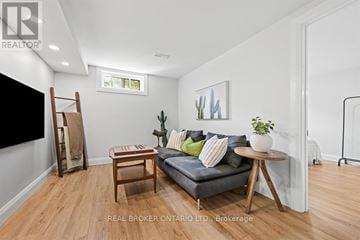 Ottawa duplex for rent - A living room with a grey couch, a wooden table, and a painting on the wall.
