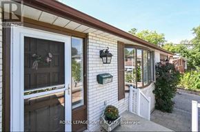 Toronto (Highland Creek) apartment for rent - A white house with a brown roof and a glass door.