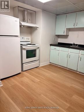 Toronto (Highland Creek) apartment for rent - A kitchen with white appliances and wooden floors.