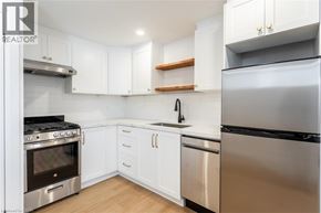 Hamilton apartment for rent - A modern kitchen with white cabinets and stainless steel appliances.