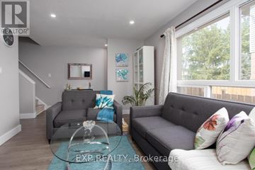 London South (South Q) townhouse for rent - A living room with a grey couch and a glass coffee table.