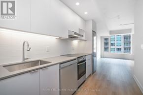 Ottawa condo for rent - A modern kitchen with stainless steel appliances and white cabinets.