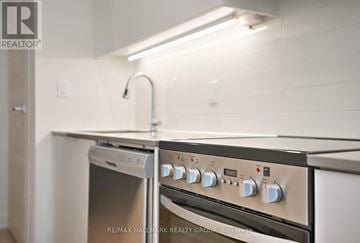 Ottawa condo for rent - A kitchen with a stove top oven and a dishwasher.