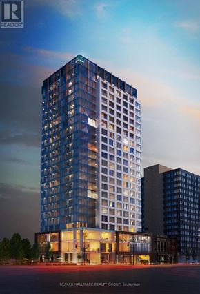 Ottawa condo for rent - A tall building with a glass facade is the main focus of the image.