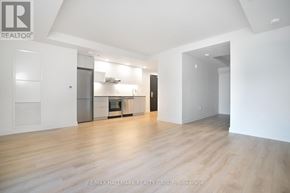 Ottawa condo for rent - A spacious, empty room with wooden floors and white walls.