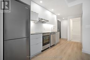 Ottawa condo for rent - A modern kitchen with a refrigerator, oven, and stove.
