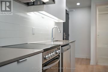 Ottawa condo for rent - A modern kitchen with a stainless steel oven and sink.