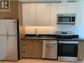 Ottawa condo for rent - A kitchen with a refrigerator, stove, and microwave.