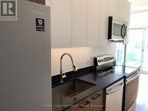 Ottawa condo for rent - A kitchen with a Samsung fridge and a microwave oven.
