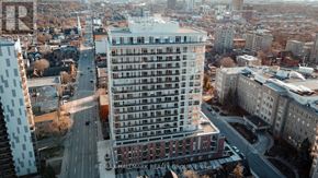 Ottawa condo for rent - A tall building with a lot of windows is in the center of the image.