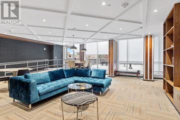 Ottawa condo for rent - A living room with a blue couch and a coffee table.
