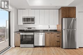 Ottawa condo for rent - A modern kitchen with stainless steel appliances and wooden accents.