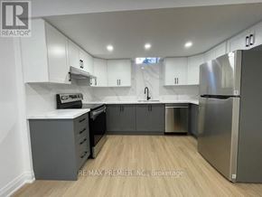 Vaughan (Vellore Village) apartment for rent - A kitchen with white cabinets and a stainless steel refrigerator.