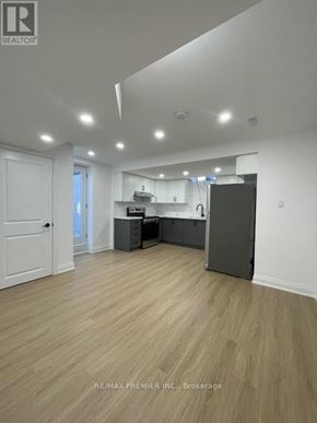Vaughan (Vellore Village) apartment for rent - A spacious room with a kitchenette and a refrigerator.