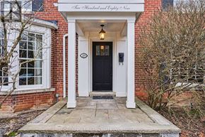 Toronto (Lawrence Park South) apartment for rent - A brick house with a black door and a white porch.