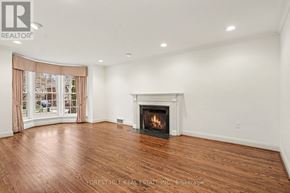 Toronto (Lawrence Park South) apartment for rent - A living room with a fireplace and wood flooring.