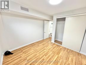 Richmond Hill (Devonsleigh) apartment for rent - A room with wooden flooring and white walls, with a black cat lying on the floor.