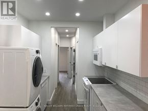 Toronto (Dovercourt-Wallace Emerson-Junction) apartment for rent - A laundry room with a washer and dryer.