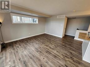 Ottawa condo for rent - A room with wooden flooring and a window.