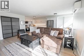 Sarnia condo for rent - A modern living room with a brown couch and a black coffee table.