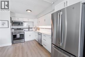 Sarnia condo for rent - A modern kitchen with a stainless steel refrigerator.