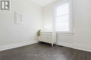 Toronto (East York) apartment for rent - A white dresser with a mirror and a potted plant sits in a room with a window.