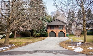 Toronto (Scarborough Village) apartment for rent - A house with a brick facade and a driveway in front.